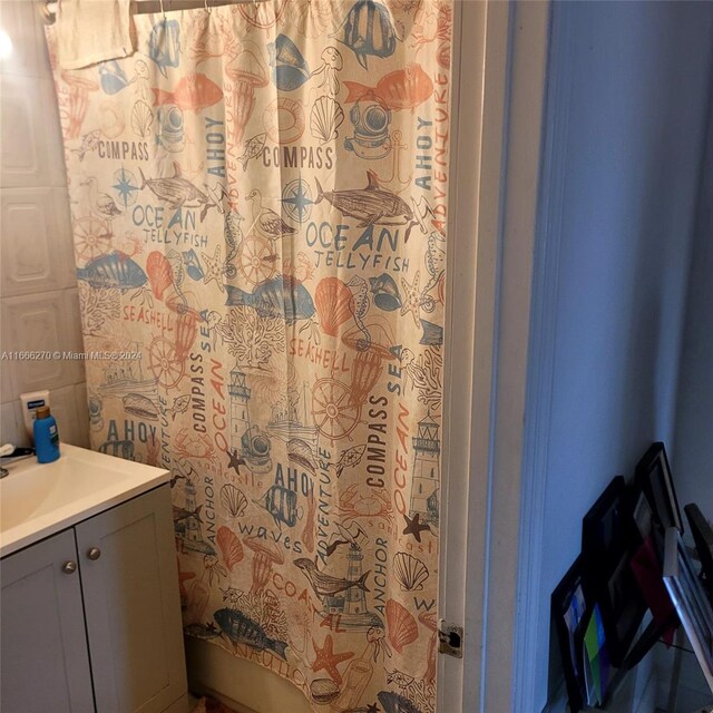 bathroom with vanity and curtained shower