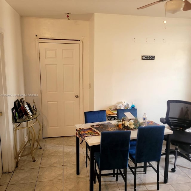 tiled dining room featuring ceiling fan