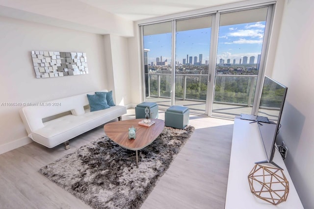 living room with hardwood / wood-style floors and expansive windows