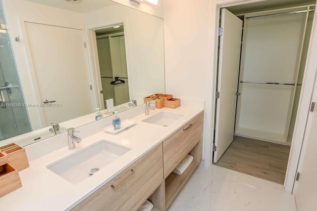 bathroom featuring vanity and an enclosed shower