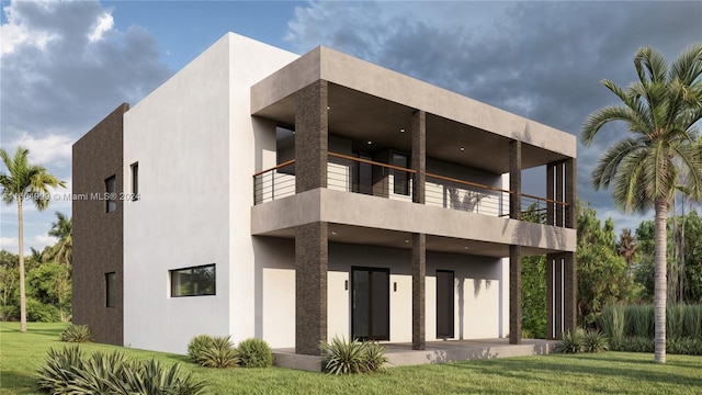 rear view of property featuring a balcony and a lawn