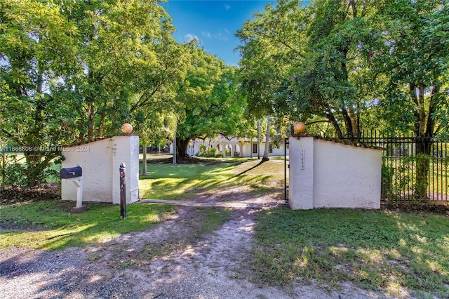 view of gate featuring a lawn