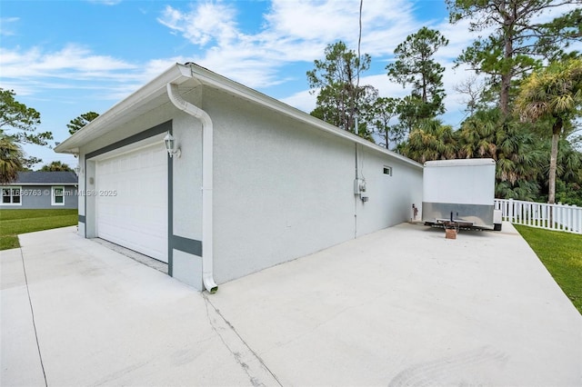 exterior space featuring a garage and a patio