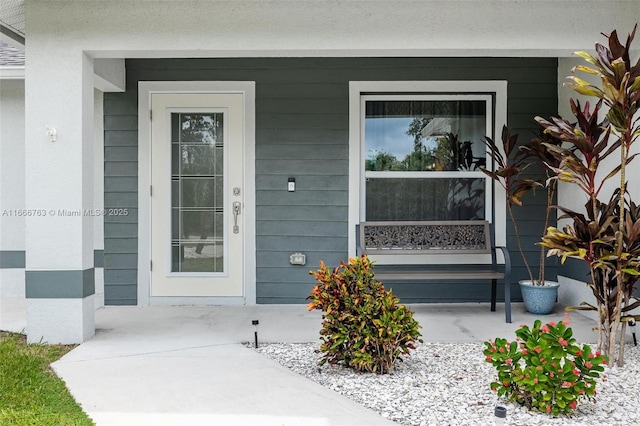 view of exterior entry with covered porch