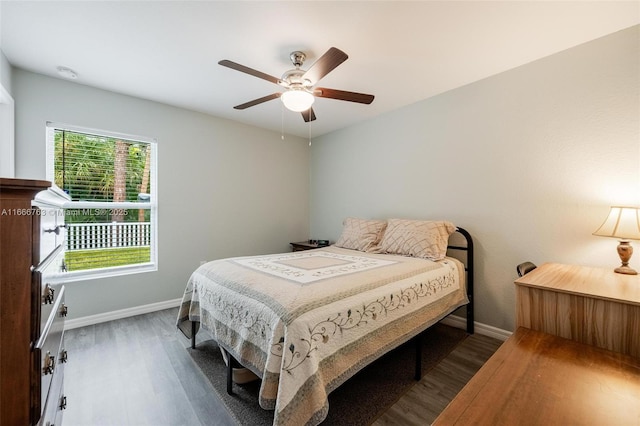 bedroom with ceiling fan and dark hardwood / wood-style flooring