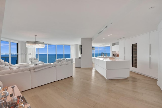 living room with a water view and light wood finished floors