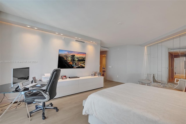 bedroom with wood finished floors and visible vents