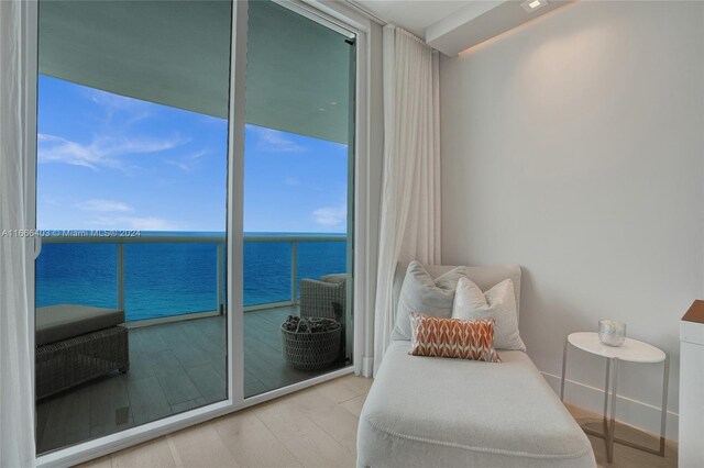 living area with wood finished floors and a water view