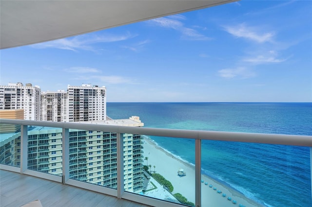 balcony with a beach view, a view of city, and a water view