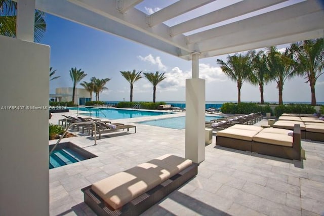 view of pool featuring a water view and a patio area