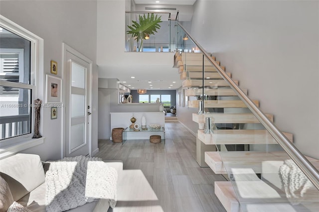 entrance foyer featuring hardwood / wood-style floors and a towering ceiling