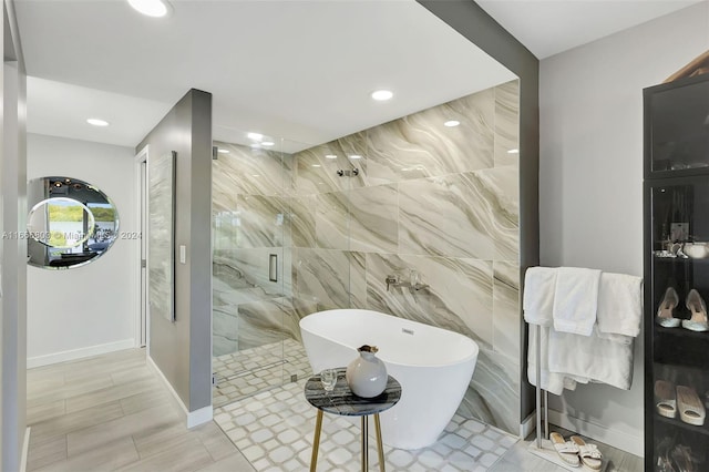 bathroom with tile walls and plus walk in shower