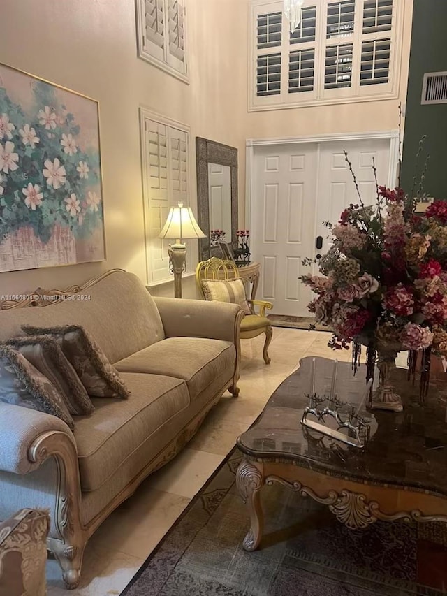 living room featuring a high ceiling and light tile patterned floors