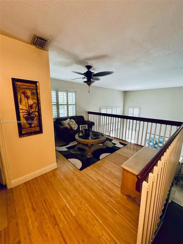 interior space with a textured ceiling and hardwood / wood-style flooring