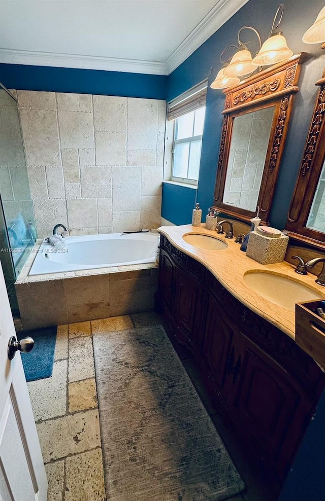 bathroom featuring ornamental molding, tiled tub, and vanity