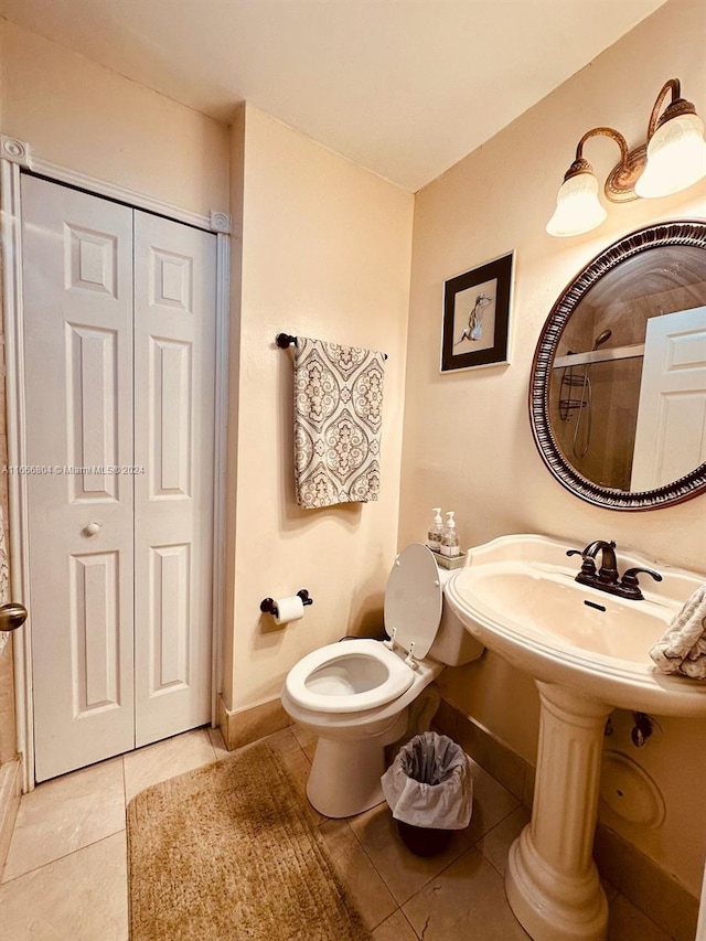 bathroom featuring walk in shower, toilet, and tile patterned floors