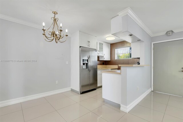 2496 SW 17th Ave Unit 5307, Miami, FL 33145 - kitchen with stainless steel fridge, glass insert cabinets, white cabinets, a peninsula, and a chandelier