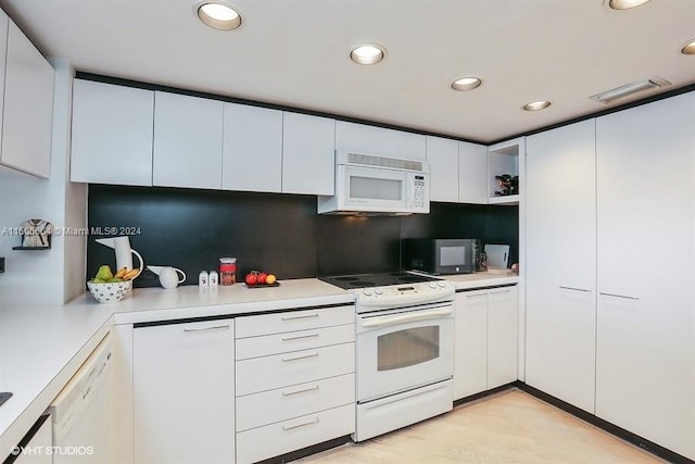 2 Grove Isle Dr Unit B1708, Miami, FL 33133 - kitchen with white appliances, white cabinets, light countertops, recessed lighting, and tasteful backsplash