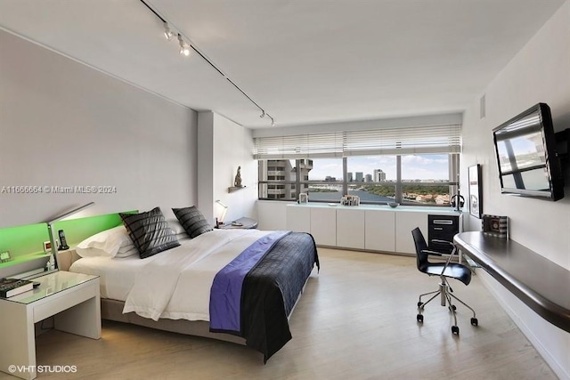 2 Grove Isle Dr Unit B1708, Miami, FL 33133 - bedroom with light wood-type flooring, a desk, and track lighting