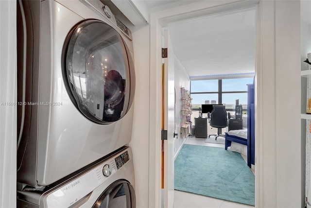 laundry area with stacked washer and dryer