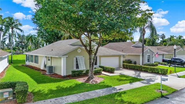 ranch-style house with central AC, a front yard, and a garage