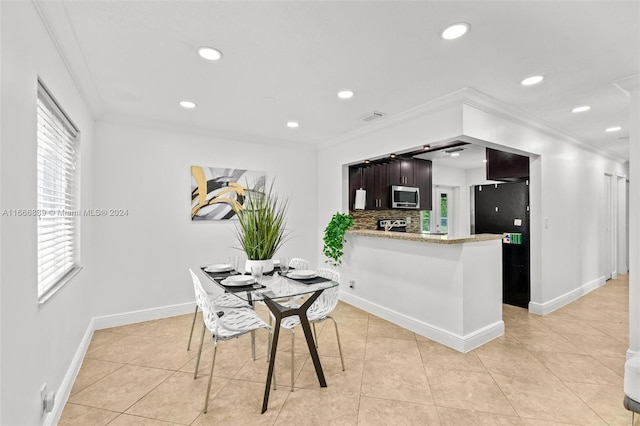 dining room featuring ornamental molding and light tile patterned floors