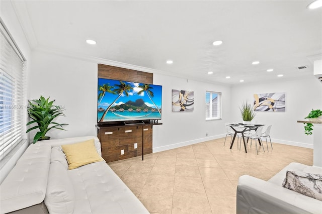 living room featuring crown molding and light tile patterned floors