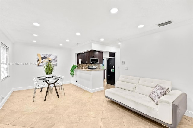 tiled living room featuring crown molding