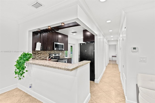 kitchen featuring decorative backsplash, kitchen peninsula, light tile patterned floors, stainless steel appliances, and dark brown cabinets