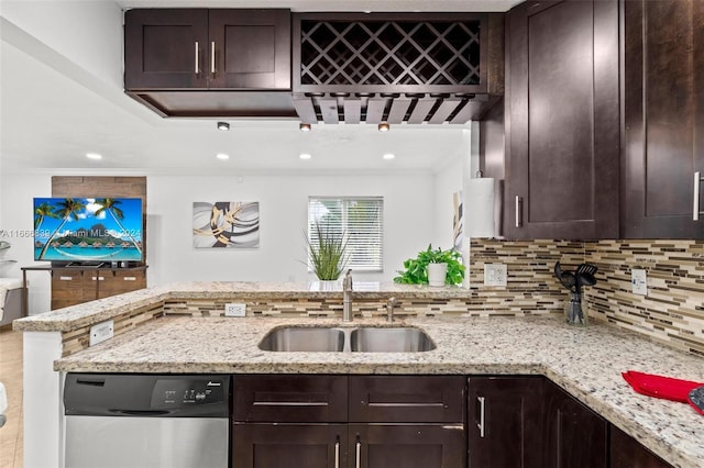 kitchen with light stone counters, dark brown cabinetry, sink, backsplash, and dishwasher