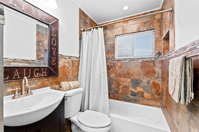 full bathroom featuring tile walls, vanity, toilet, and shower / bath combination with curtain