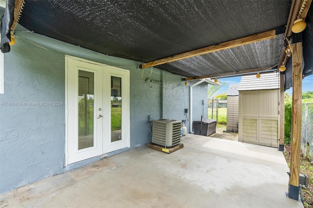 view of patio / terrace featuring french doors, a shed, and central AC unit