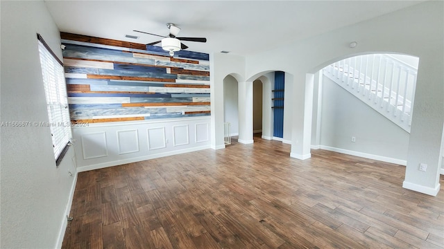 unfurnished living room with hardwood / wood-style flooring and ceiling fan