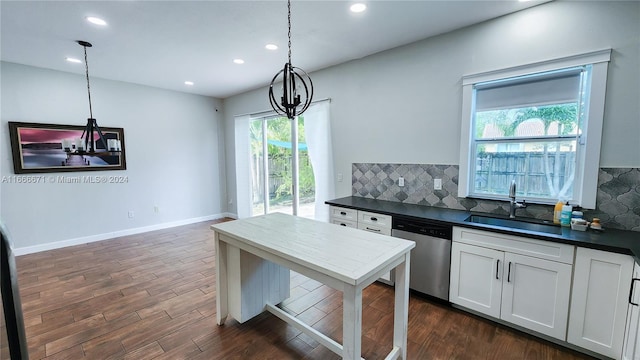 kitchen featuring white cabinetry, plenty of natural light, pendant lighting, and dishwasher