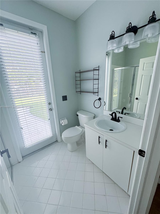 bathroom with walk in shower, tile patterned flooring, vanity, and toilet