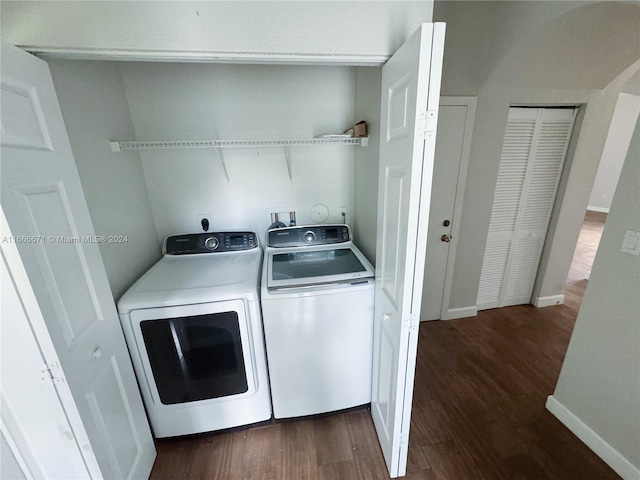 clothes washing area featuring washing machine and clothes dryer and dark hardwood / wood-style floors