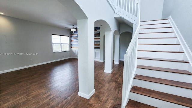 staircase with hardwood / wood-style flooring and ceiling fan