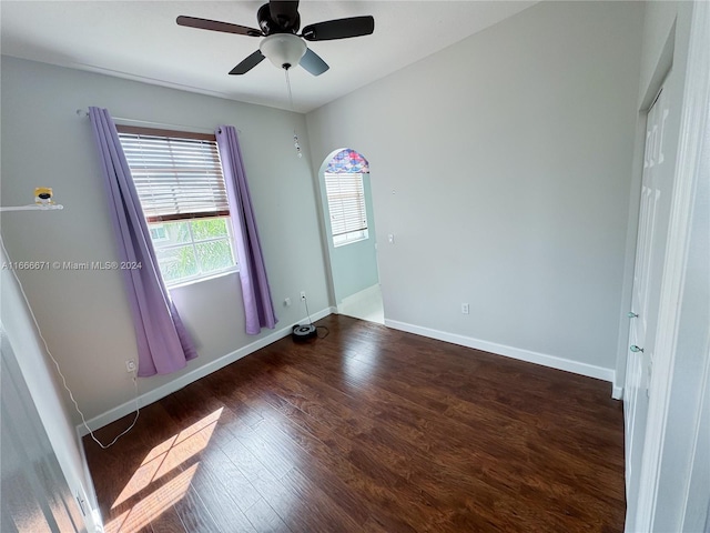 spare room featuring ceiling fan and dark hardwood / wood-style floors