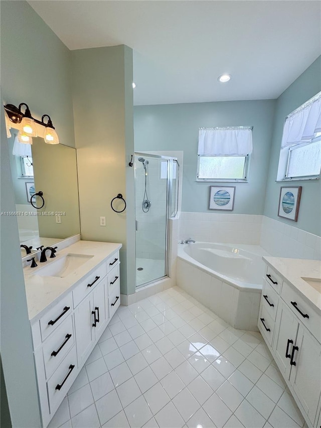 bathroom featuring independent shower and bath, vanity, and tile patterned floors