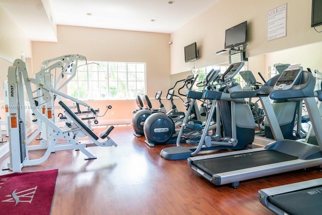 exercise room with dark wood-type flooring