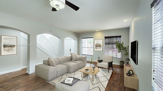 living room with wood-type flooring and ceiling fan