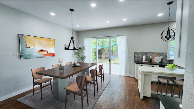 dining space with a notable chandelier and dark hardwood / wood-style floors