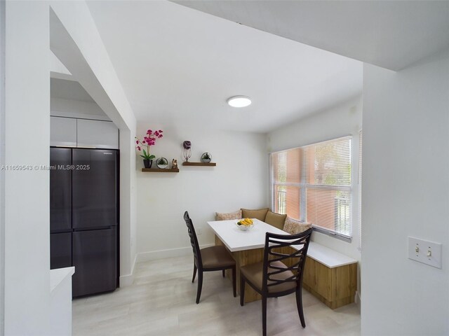 kitchen featuring white cabinets, sink, kitchen peninsula, black appliances, and decorative backsplash