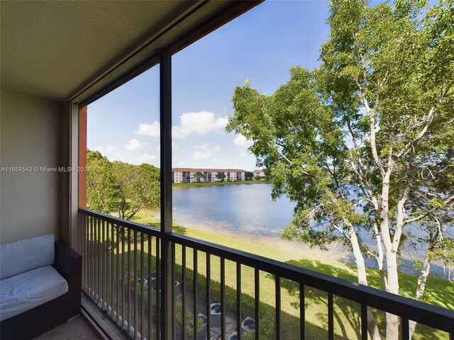 balcony featuring a water view