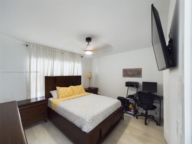 bedroom with light hardwood / wood-style flooring and ceiling fan