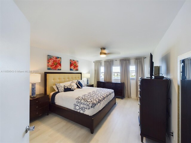 bedroom with light hardwood / wood-style floors and ceiling fan