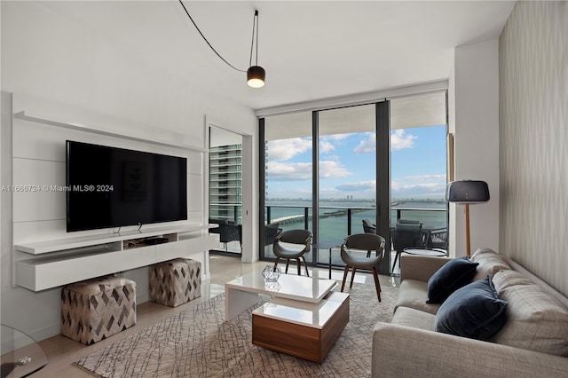 living room featuring a wall of windows and a water view