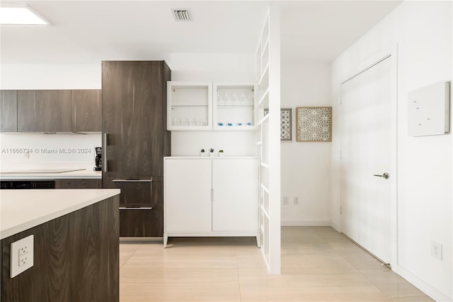 kitchen featuring dark brown cabinetry