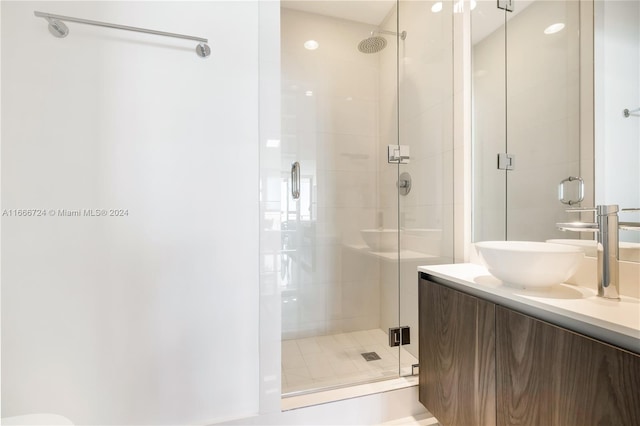 bathroom with vanity and a shower with shower door