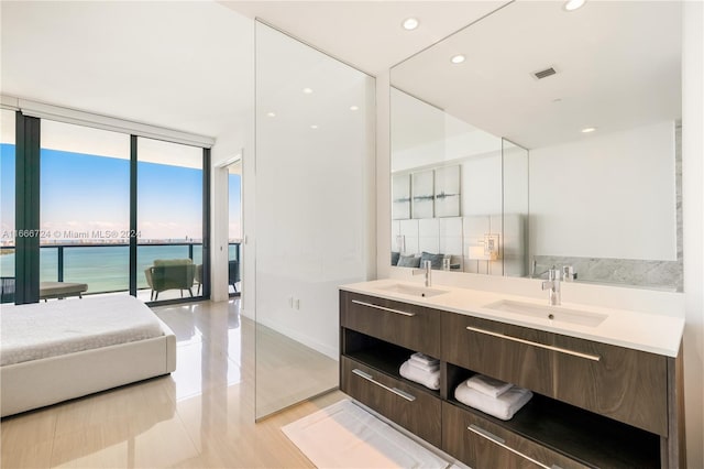 bathroom featuring a water view, vanity, and hardwood / wood-style flooring